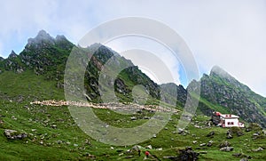 Hikers walking on tourist trail in mountains.