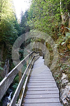 Hiking along the canyon Gorges Mysterieuses de Tete Noire in Trient, region of Martigny in Valais, Swiss Alps, Switzerland