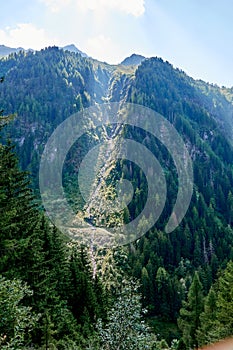 Hiking along the watercourse of Bisse of Trient in the Swiss alps in the region of Martigny in Valais, Switzerland