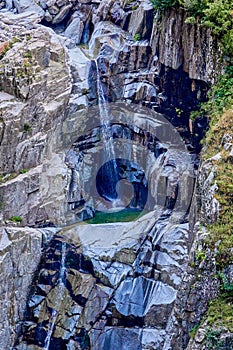 Hiking along the watercourse of Bisse of Trient in the Swiss alps in the region of Martigny in Valais, Switzerland