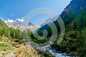 Hiking along the watercourse of Bisse of Trient in the Swiss alps in the region of Martigny in Valais, Switzerland