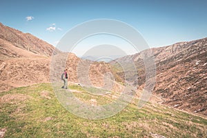 Hiking in the Alps on panoramic footpath, toned image