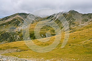 Hiking on a autumn cloudy sunday, in the high mountains. photo
