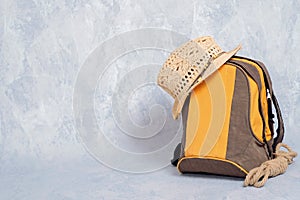 Hiking backpack with rope and straw hat on grey background, banner mockup with copy space for your text, concept of adventure, hik