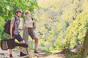 Hiking backpacking couple reading map on trip.