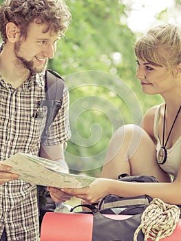 Hiking backpacking couple reading map on trip.