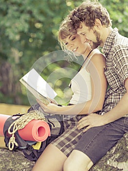 Hiking backpacking couple reading map on trip.