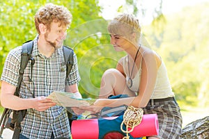 Hiking backpacking couple reading map on trip