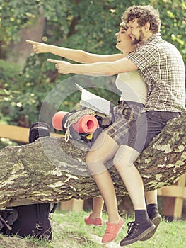 Hiking backpacking couple reading map on trip.