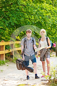 Hiking backpacking couple reading map on trip.