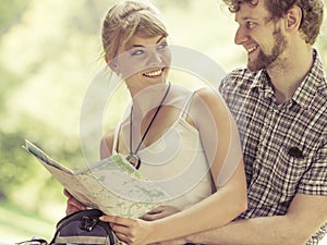 Hiking backpacking couple reading map on trip.