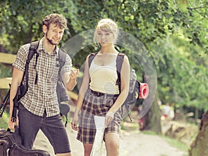 Hiking backpacking couple reading map on trip.