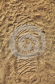 Hiking boot print in the dirt on a trail
