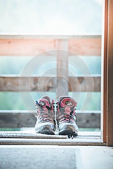 Hiking boots inside of a rustic mountain chalet, Austria photo