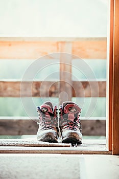 Hiking boots inside of a rustic mountain chalet, Austria photo