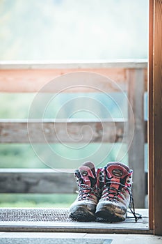 Hiking boots inside of a rustic mountain chalet, Austria photo