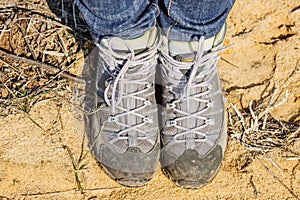 Hiking boots standing on the sand in the mountain