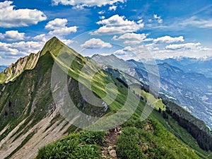 Hiking on the breathtaking Hardergrat in the Bernese Alps. Extremely dangerous path on the mountain ridge