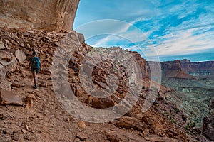 Hiking Canyonlands Backpacker on the trail to False Kiva