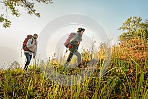 Hiking couple with backpack walking on mountain