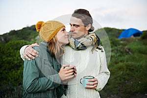 Hiking, couple and drinking coffee in nature on vacation, holiday or travel together in winter on adventure. Camping