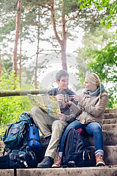 Hiking couple having break on forest trail