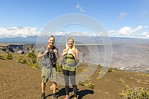 The Hiking couple seeing volcano national park from crater on the caldera Halemaumau around Hawaii volcanoes national photo