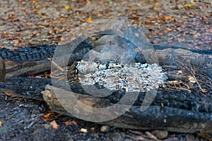 Hiking fire place bbq in forest with small fire and ash