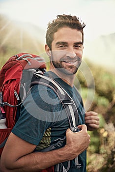 Hiking, fitness and portrait of man on mountain for peace, adventure and travel journey. Backpacking, summer and workout