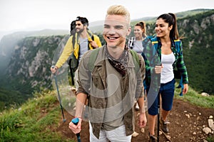 Hiking with friends is so fun. Group of young people with backpacks together