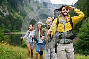 Hiking with friends is so fun. Group of young people with backpacks together