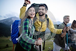 Hiking with friends is so fun. Group of young people with backpacks walking together