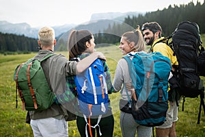 Hiking with friends is so fun. Group of young people with backpacks walking together