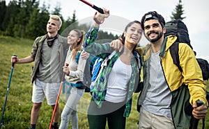 Hiking with friends is so fun. Group of young people with backpacks walking together