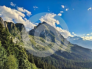 hiking in the Glarner Alp. View of the Fronalpstock mountain above Mollis. Beautiful sunset hike towards Nuenchamm