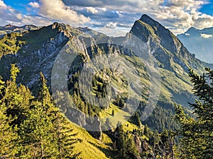 hiking in the Glarner Alp. View of the Fronalpstock mountain above Mollis. Beautiful sunset hike towards Nuenchamm