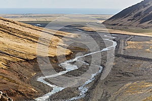 Hiking in Iceland, rugged valleys, black sediment