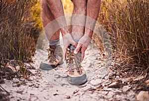 Hiking, injury and shoes of man in nature for leg pain, training and accident. Emergency, healthcare and inflammation