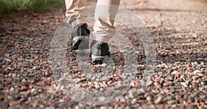 Hiking, legs or person walking on path for fitness for adventure, trekking or freedom. Closeup of shoes, mountain trail