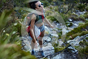 Hiking, location and nature with woman in mountains for adventure, discovery or exploration. Backpack, environment and
