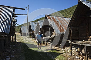 Hiking Lycian way. Man is trekking next to Traditional wooden depots in Bezirgan highlands on Lycian Way trail