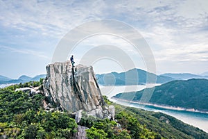 Hiking man alsone on Amazing view of High Island Reservoir, Countryside Park, Sai Kung, Hong Kong, daytime