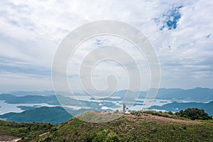 Hiking man alsone on Amazing view of High Island Reservoir, Countryside Park, Sai Kung, Hong Kong, daytime