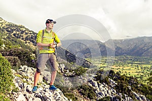 Hiking man checking direction in mountains