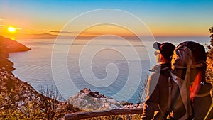 Hiking man enjoying scenic sunrise from the Path of the Gods between Positano and Praiano on the Amalfi Coast, Campania, Italy