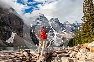 Hiking Man Looking at Moraine Lake and Rocky Mountains, Canada photo