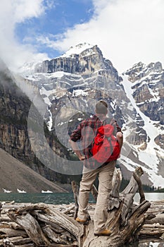 Hiking Man Looking at Moraine Lake & Rocky Mountains photo