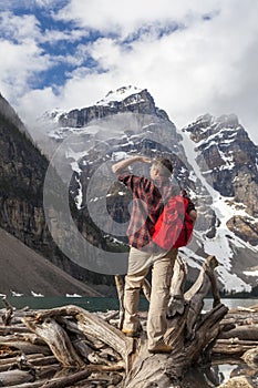 Hiking Man Looking at Moraine Lake & Rocky Mountains photo