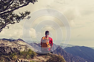 Hiking man or trail runner looking at mountains