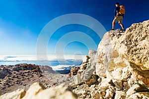 Hiking man or trail runner looking at view in mountains